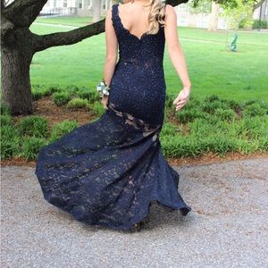 Stunning sleeveless lace navy jovani gown with plunging neckline and sheer panel